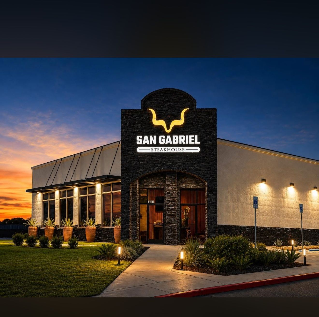 San Gabriel Steakhouse at dusk, glowing entrance sign and warmly lit storefront